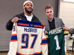 O astro da NHL Connor McDavid troca de camisa com o NFL All-Pro Micah Parsons