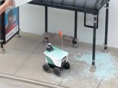 Robô de entrega autodirigido se dirige diretamente através de um abrigo de ônibus