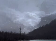 Turistas chineses assistem a uma enorme avalanche descer montanha abaixo